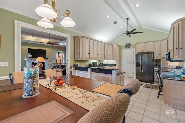 kitchen featuring dark countertops, cream cabinetry, appliances with stainless steel finishes, and ceiling fan