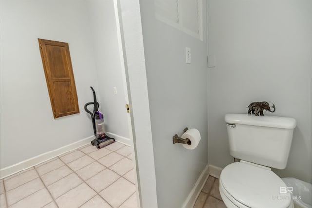 bathroom featuring tile patterned floors, baseboards, and toilet