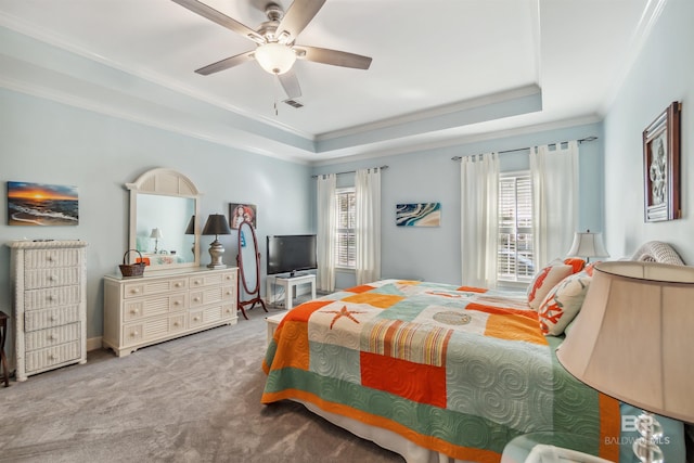 carpeted bedroom featuring a raised ceiling, multiple windows, and crown molding