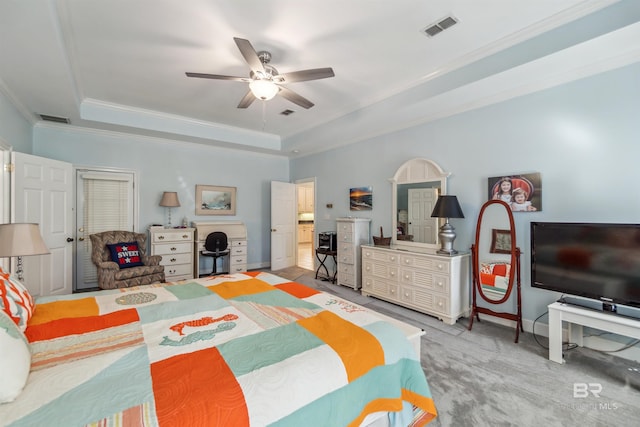 bedroom featuring a raised ceiling, baseboards, visible vents, and ornamental molding