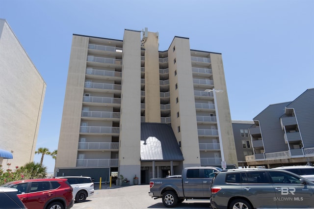 view of building exterior featuring uncovered parking