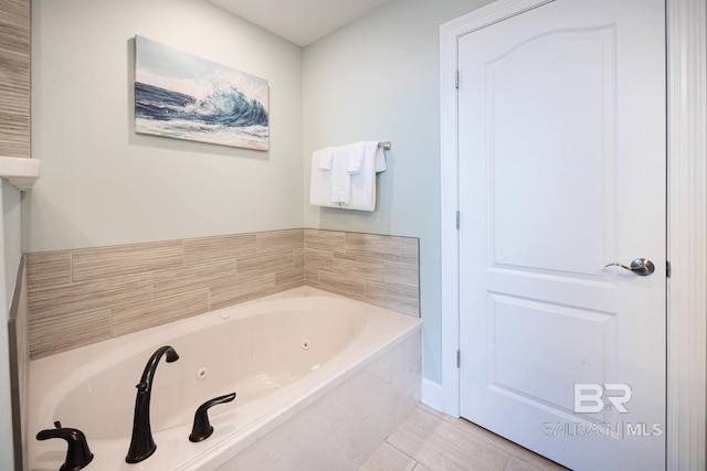 bathroom featuring tile patterned flooring and a bathing tub