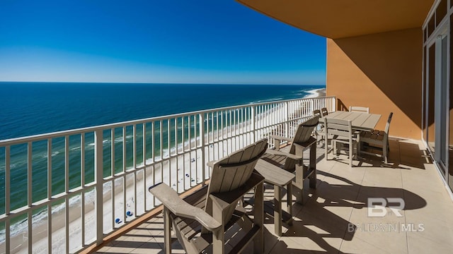 balcony featuring a water view and a view of the beach