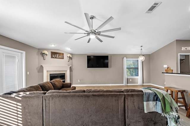 living room featuring ceiling fan, hardwood / wood-style floors, and lofted ceiling