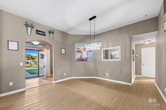 entrance foyer featuring a notable chandelier and light wood-type flooring