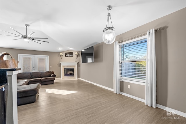 living room featuring french doors, light hardwood / wood-style flooring, and ceiling fan