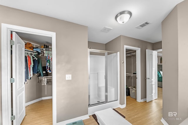 bathroom with walk in shower and hardwood / wood-style flooring