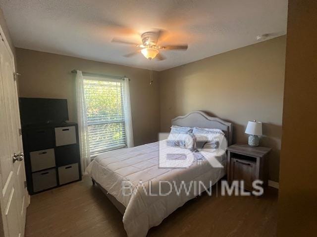 bedroom with ceiling fan and hardwood / wood-style flooring