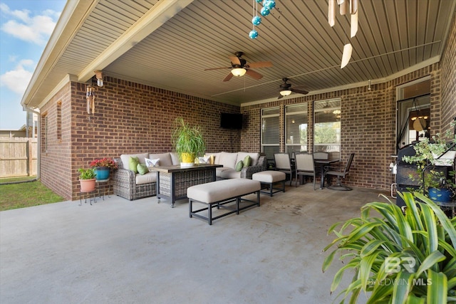 view of patio / terrace with a ceiling fan, fence, an outdoor hangout area, and outdoor dining space