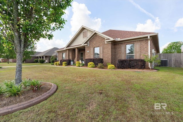 craftsman inspired home with fence, central air condition unit, a front lawn, and brick siding