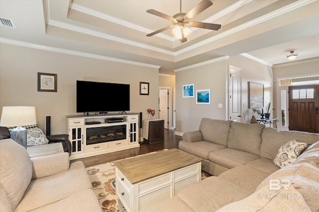 living room featuring visible vents, a raised ceiling, ceiling fan, and dark wood-style floors