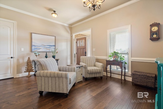 sitting room with crown molding, baseboards, a chandelier, and dark wood-type flooring