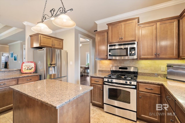 kitchen featuring crown molding, appliances with stainless steel finishes, light stone counters, backsplash, and a kitchen island