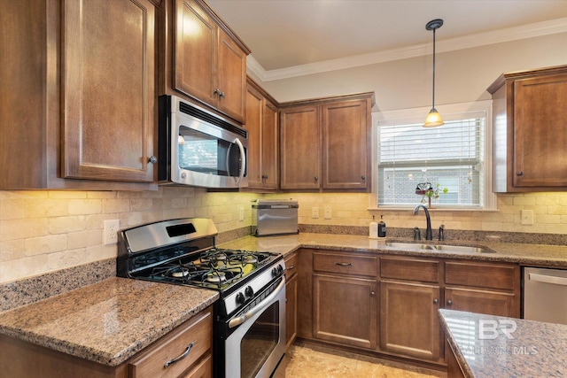 kitchen with decorative backsplash, ornamental molding, light stone countertops, a sink, and appliances with stainless steel finishes