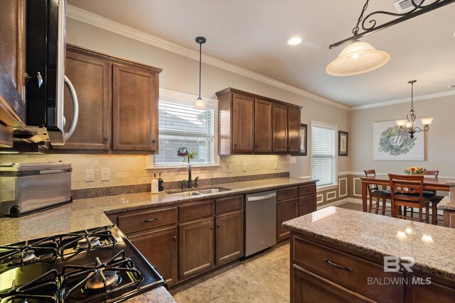 kitchen with crown molding, gas stove, a sink, decorative backsplash, and stainless steel dishwasher