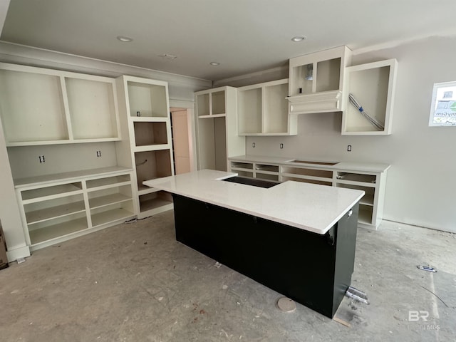 kitchen featuring stovetop, open shelves, and a center island