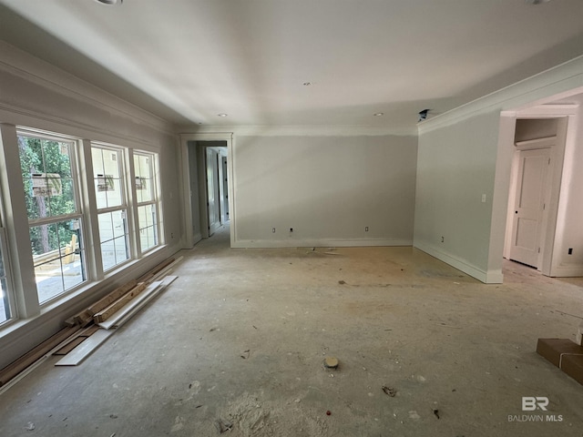 unfurnished room featuring a baseboard radiator, ornamental molding, and baseboards