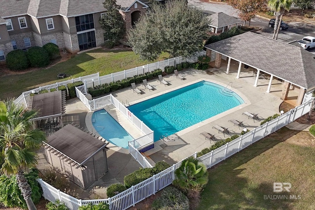 view of swimming pool with a patio area and a yard