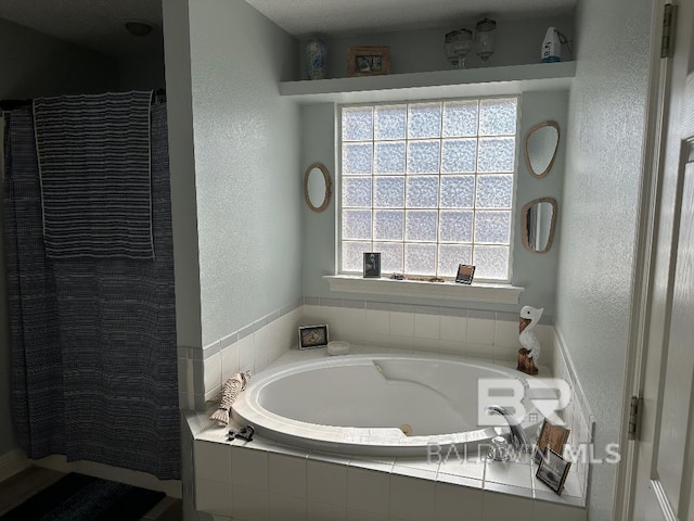 bathroom with separate shower and tub