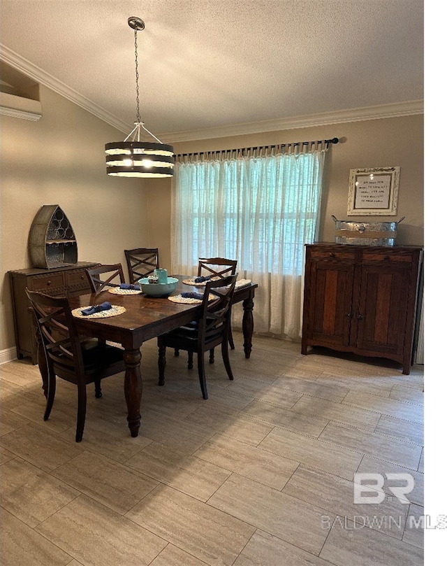 dining space with a notable chandelier, a textured ceiling, and ornamental molding