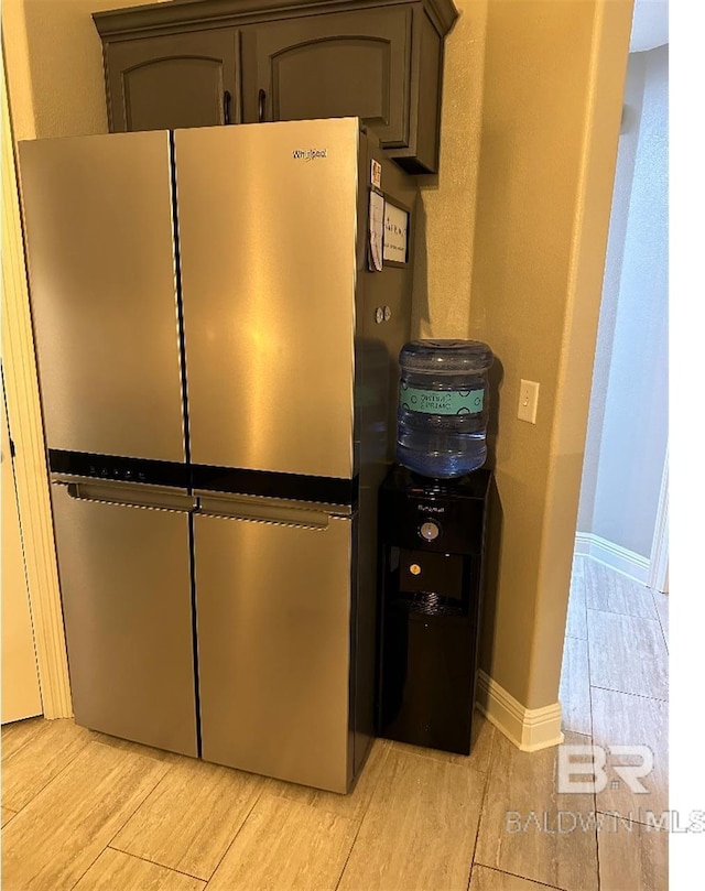 details with stainless steel fridge and light hardwood / wood-style floors