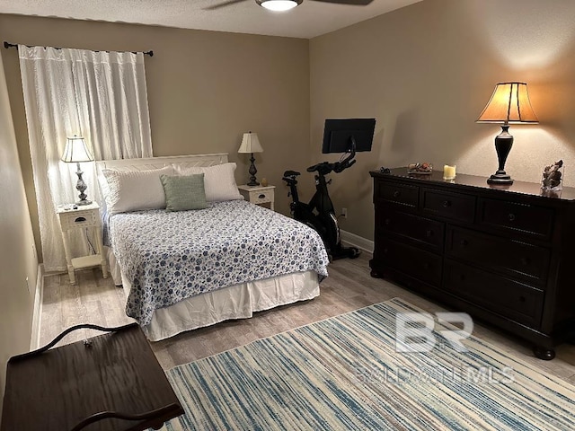 bedroom featuring light hardwood / wood-style flooring and ceiling fan