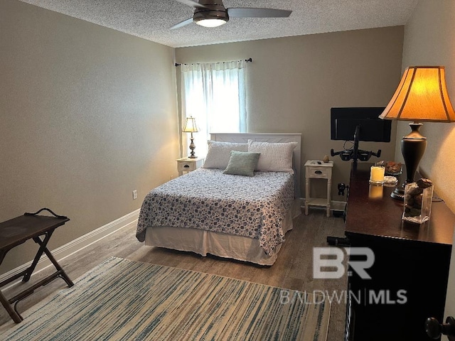 bedroom featuring wood-type flooring, a textured ceiling, and ceiling fan