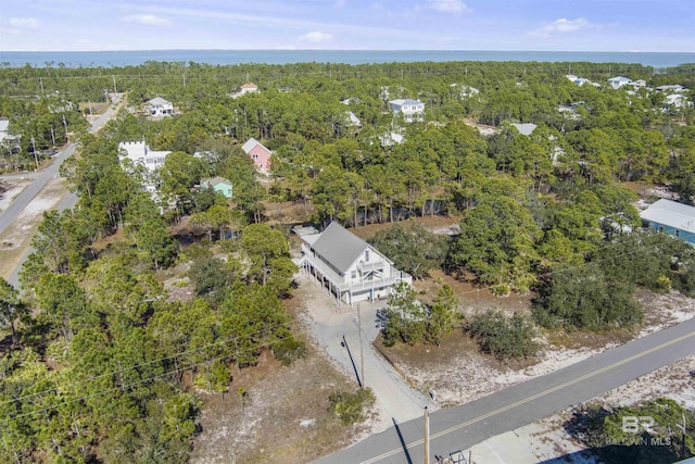 drone / aerial view featuring a wooded view