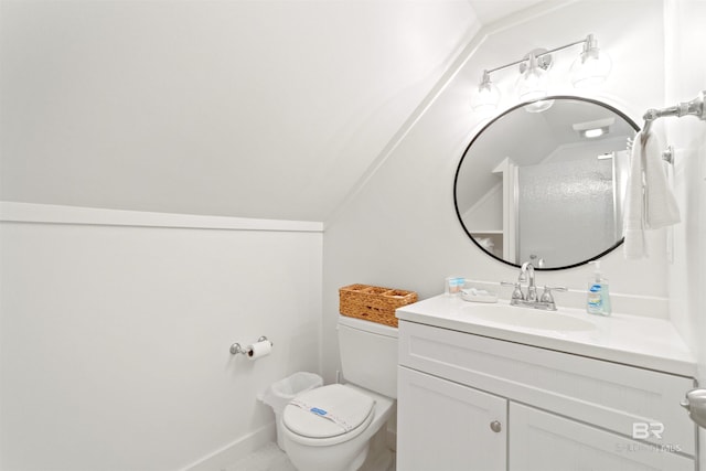 bathroom with baseboards, vaulted ceiling, vanity, and toilet