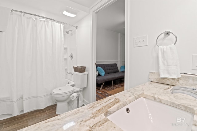 full bath featuring toilet, a shower with shower curtain, vanity, and wood tiled floor