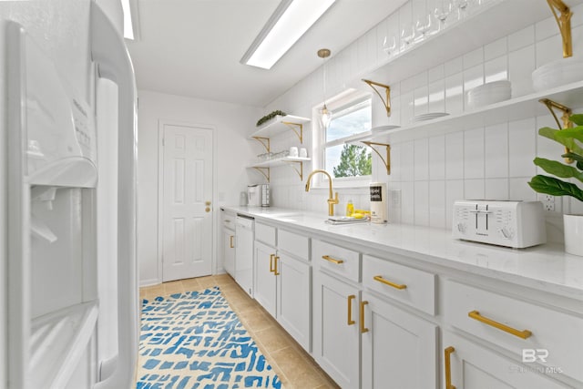 kitchen with white appliances, white cabinets, light stone countertops, open shelves, and backsplash