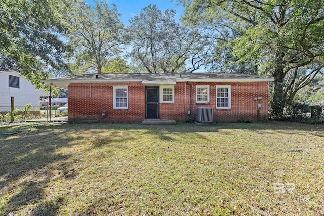 back of house featuring a yard and central AC