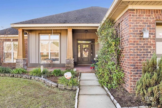 view of exterior entry with covered porch