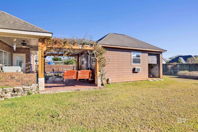 back of property with ceiling fan, a pergola, a yard, and a patio