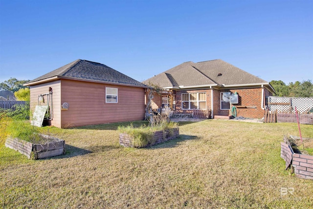 rear view of property featuring a lawn