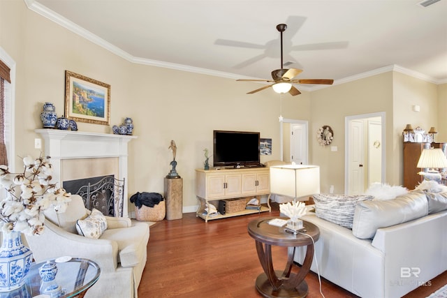 living room featuring ceiling fan, dark hardwood / wood-style flooring, and ornamental molding