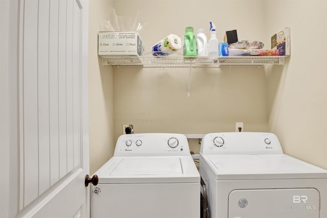 clothes washing area with separate washer and dryer