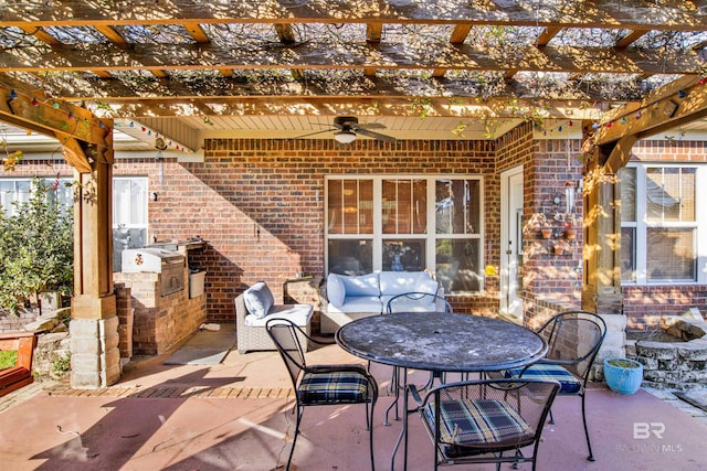 view of patio featuring a pergola, ceiling fan, and exterior kitchen