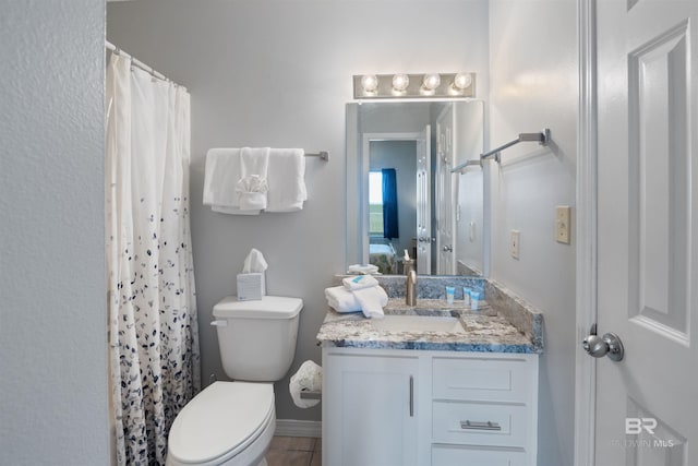 bathroom with vanity, a shower with shower curtain, and toilet