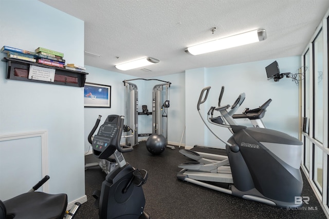 exercise room featuring a textured ceiling