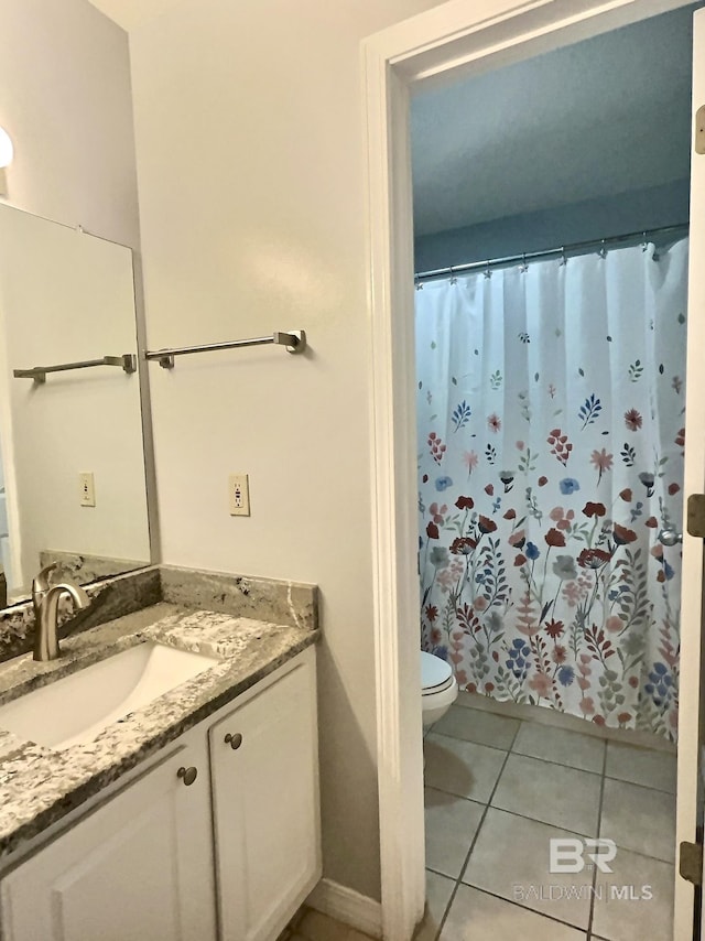 bathroom featuring tile patterned floors, toilet, a shower with shower curtain, and vanity