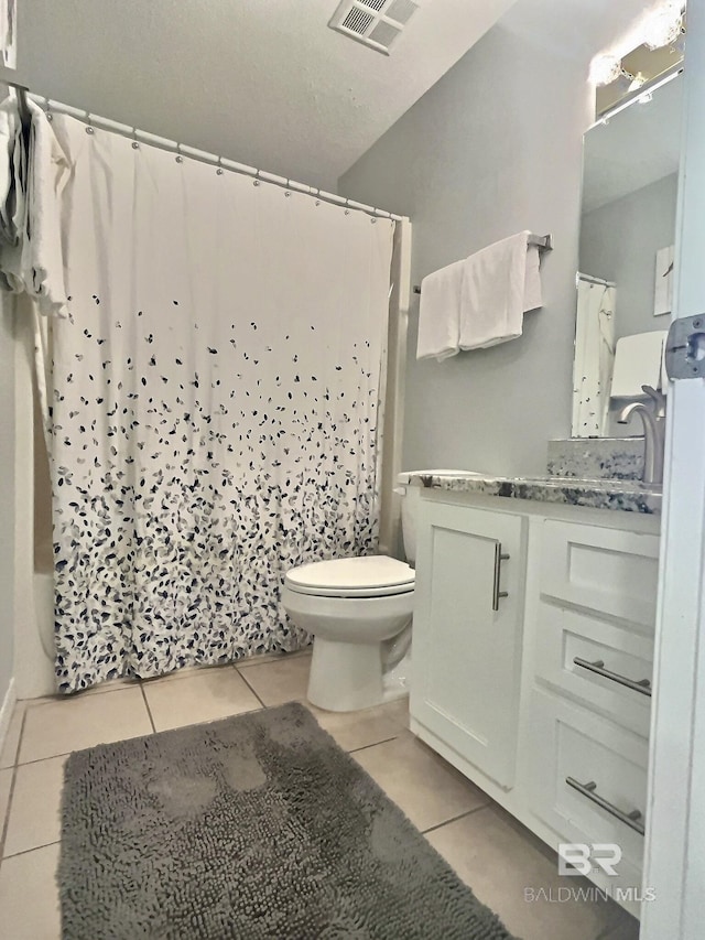 bathroom with vanity, tile patterned floors, and toilet