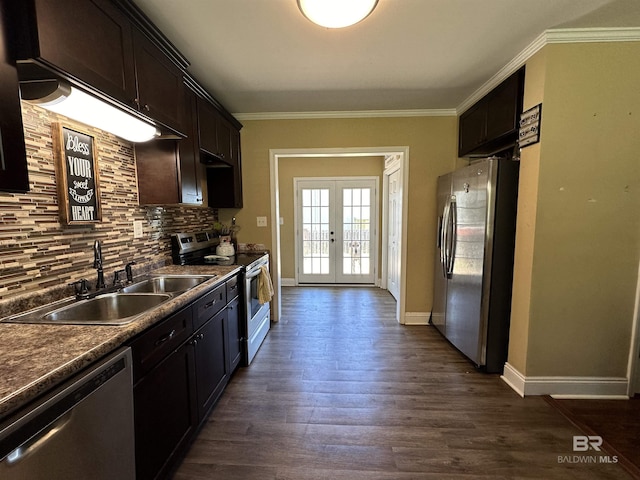 kitchen featuring a sink, stainless steel appliances, decorative backsplash, ornamental molding, and french doors