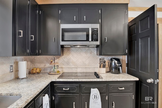 kitchen featuring decorative backsplash and black electric stovetop