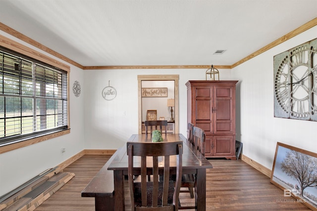 dining area featuring dark hardwood / wood-style floors and crown molding