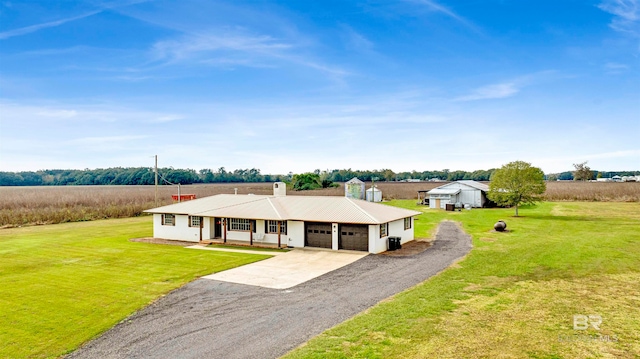 single story home featuring a porch, a rural view, and a front lawn