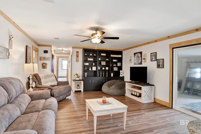 living room with hardwood / wood-style flooring, ceiling fan, and ornamental molding