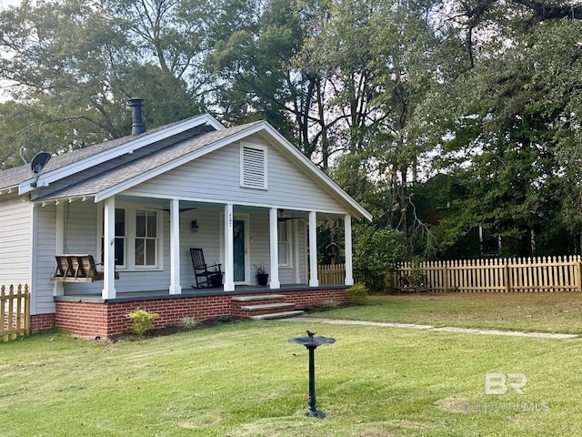 view of front of property with a front yard and a porch