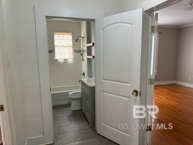 full bathroom with toilet, hardwood / wood-style floors, tiled shower / bath, vanity, and crown molding