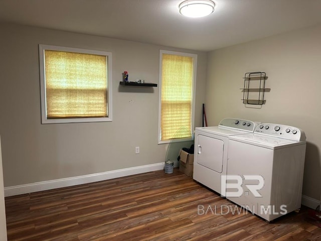 clothes washing area with separate washer and dryer and dark hardwood / wood-style floors